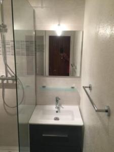 a bathroom with a sink and a shower with a mirror at STUDIO la TOUSSUIRE EN SAVOIE in La Toussuire