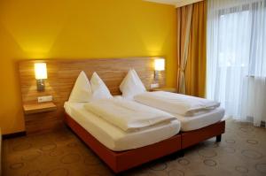 Postel nebo postele na pokoji v ubytování Gasthof Landhotel Hubmann