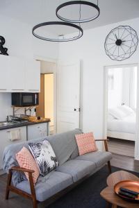 a living room with a couch and a bedroom at Appartements de Jeanne in Lille +24 photos