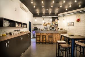 a large kitchen with a bar and tables in a restaurant at Koisi Hostel in San Sebastián