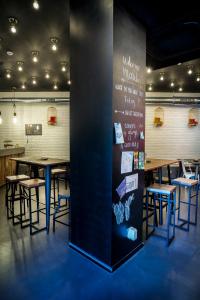 a dining room with tables and chairs and a wall at Cats Hostel San Sebastian in San Sebastián +53 photos