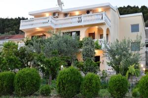 a house with trees in front of it at Bisha Apartments in Ulcinj