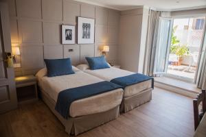 Posteľ alebo postele v izbe v ubytovaní Hotel Doña Blanca