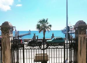 a car parked behind a gate near the ocean at B&B Albatros in Lipari