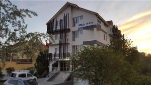a building with a car parked in front of it at Blue Wave in Mamaia Sat/Năvodari