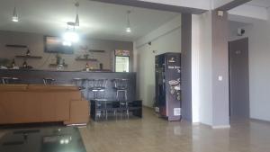 a room with a bar with bar stools and a counter at Blue Wave in Mamaia Sat/Năvodari