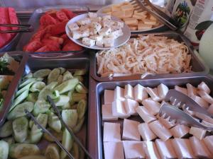 a buffet of different types of food in trays at Mercan Bungalow in Cıralı