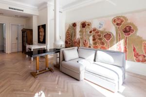 ミラノにあるHouse of Art Giovioのリビングルーム(白いソファ、テーブル付)