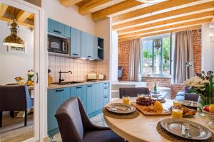 una cocina con armarios azules y una mesa con comida. en Heritage suites Zanini en Hvar