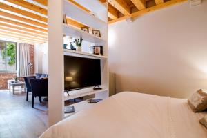 a bedroom with a bed and a tv in a room at Heritage suites Zanini in Hvar