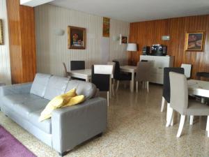 a living room with a couch and a dining room at Hotel Puente de los Santos in Tapia de Casariego