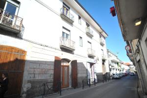 a woman walking down a street next to a building at Palazzo Mascolo gruppo mascololuxuryapartments in Agerola