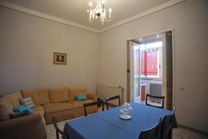 a living room with a blue table and a couch at Palazzo Mascolo gruppo mascololuxuryapartments in Agerola
