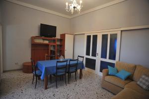 a living room with a blue table and chairs at Palazzo Mascolo gruppo mascololuxuryapartments in Agerola