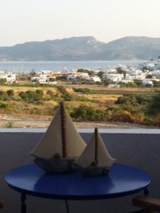 a toy boat sitting on a table in front of a window at Kapetan Giannis in Adamantas