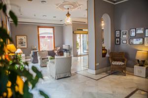 a living room with couches and chairs in a room at Hotel Doña Blanca in Jerez de la Frontera