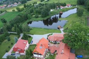 an aerial view of a house with a pond and a house at Gościniec Czapla in Dywity