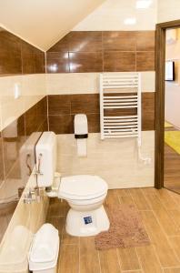 a bathroom with a white toilet in a room at Cantry Ételbár in Balkány