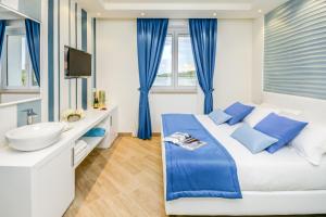 Posteľ alebo postele v izbe v ubytovaní Hotel Villa Garuti