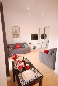 a living room with a couch and a table at Nowy Apartament Wilcza in Warsaw