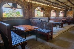 a row of tables and benches in a restaurant at Alkatraz in Gribovka