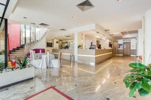 a lobby with tables and chairs in a building at Best Western Hotel Rocca in Cassino