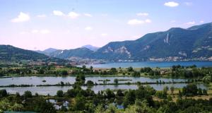 a lake with mountains and a mountain range at Agriturismo Forest in Iseo