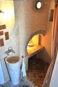 a kitchen with a brick oven in a bathroom at Folegandros-Cliffhouse in Chora Folegandros