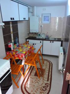 a small kitchen with a table and a sink at Casa Albert in Constanţa