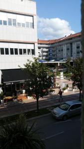 a man walking down a street in front of a building at Apartment S&T in Tivat