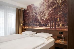 Postel nebo postele na pokoji v ubytování HYPERION Hotel Berlin + 33 fotografií