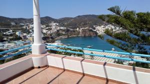 a white cross on a balcony with a view of a harbor at Villa Glicine in Ponza