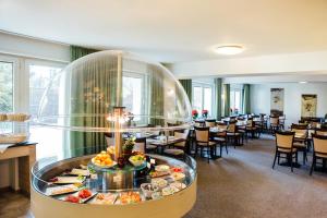 a buffet in a restaurant with tables and chairs at Hotel Astoria Bonn in Bonn