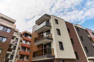 a building with balconies on the side of it at Domus Apartments City Center in Plovdiv