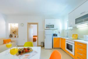 a kitchen with a table with a plate of fruit on it at Villa Ive in Mlini
