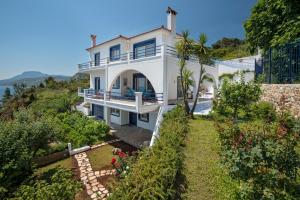 a white house with a view of the ocean at Blue Dream villa a seaside beauty in Euboea island in Platána