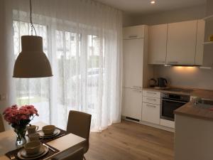 a kitchen with a table and a kitchen with a window at Apartment unter den Weinbergen in Königswinter