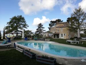 a swimming pool in the yard of a house at Il Podere Degli Artisti in San Casciano dei Bagni