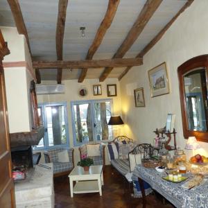 a living room with a couch and a table at Domaine De La Mouthe in Saint-Rémy