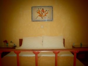 A bed or beds in a room at Phyllis Maisonettes
