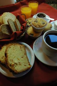 a table topped with a plate of bread and cupcakes at Hosteria Belvedere in Villa La Angostura