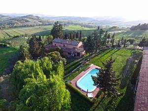 an aerial view of a villa with a swimming pool and trees at Podere Assolatina Agriturismo in San Casciano dei Bagni