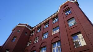 a red brick building with a blue sky in the background at Happy Cat in Odesa