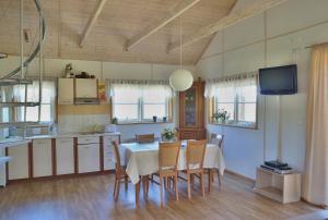 a kitchen and dining room with a table and chairs at Domek na Wzgórzu in Wojcieszyce