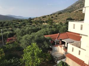 an aerial view of a house with mountains in the background at Tholos Rooms in Kavoúsion