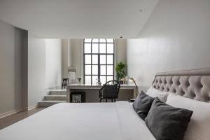 a bedroom with a bed and a desk and a window at Hotel Once Bangkok in Bangkok