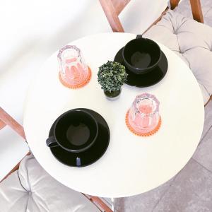 a white table with three bowls and a plant on it at Gaia Serifos Apartments in Rámos