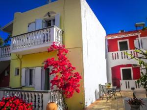 a building with flowers on the side of it at Aggelos Studios in Panormos Kalymnos
