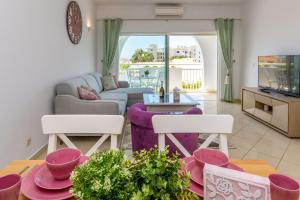 a living room with a couch and a table at Camilla apartment in Albufeira