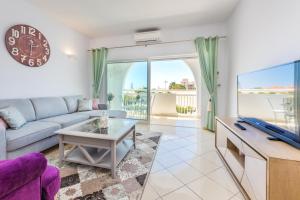 a living room with a couch and a table at Camilla apartment in Albufeira